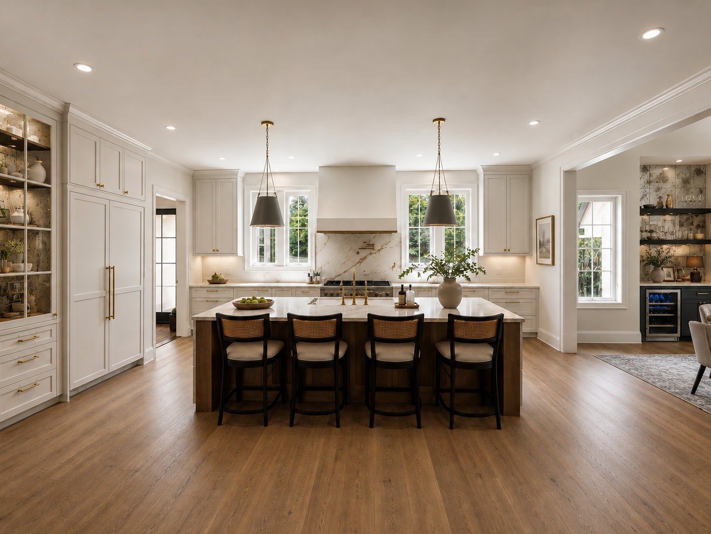 Kitchen with island seating, paneled appliances and a glass-front display cabinet